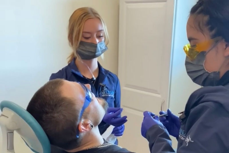 Patient being examined by dental staff member of the dental practice