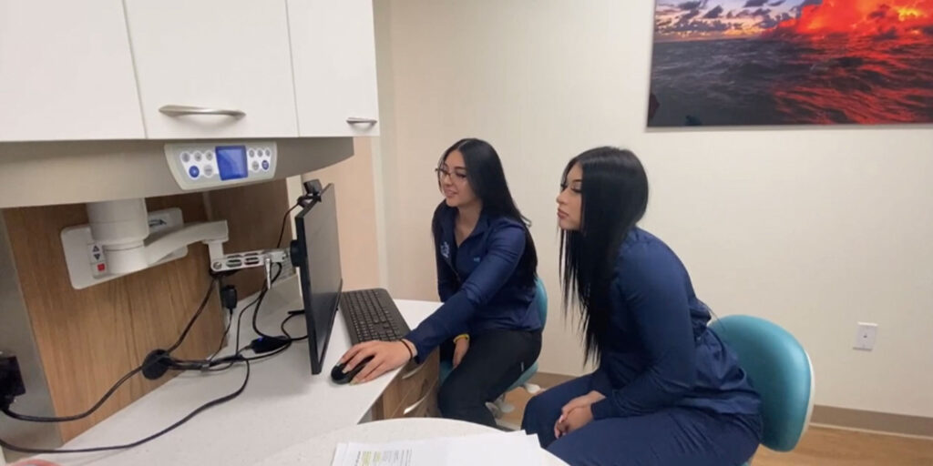 Staff member going over dental procedure information within the dental practice