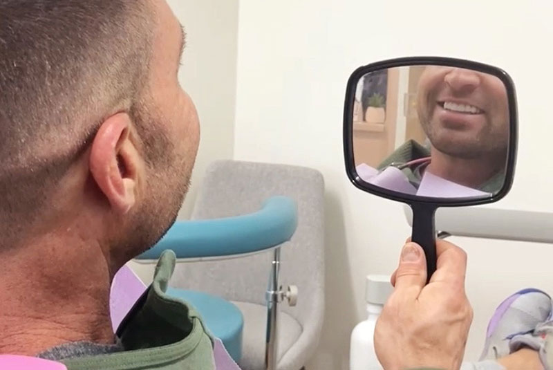 Patient smiling confidently after their dental procedure