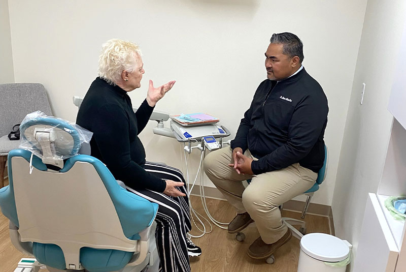 Doctor and patient discussing dental procedure within the dental practice