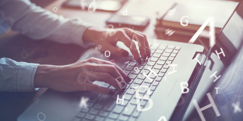 Writer typing blogs on Laptop