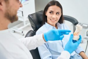 Patient consulting with dentist about implants.