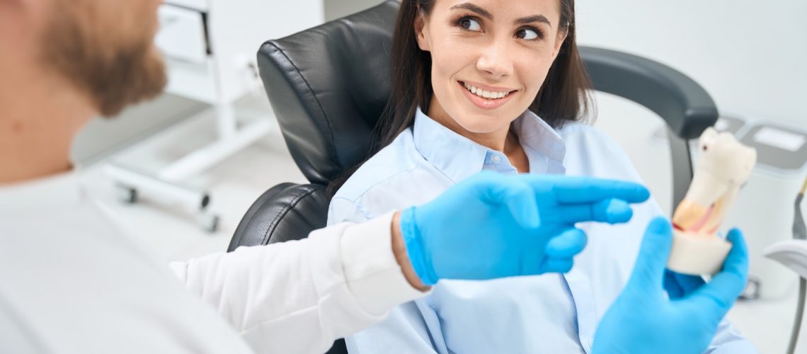 Patient consulting with dentist about implants.
